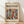 May include: Framed exhibition poster featuring abstract modernist artwork with colorful dancing figures in vibrant reds, greens, blues, and purples. Wooden frame displays against white wall on light wooden floor with soft natural lighting creating diagonal shadows across the scene.