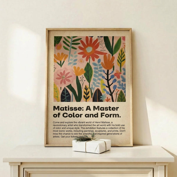 May include: Framed art print with colorful botanical illustration featuring stylized flowers and leaves in coral, orange, green, and blue tones on pink background, displayed on light wood console table next to small wrapped gift box with twine bow against cream wall