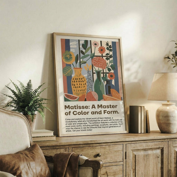 May include: Framed art print with colorful still life featuring yellow vase, green bottles, flowers, and fruit in modern abstract style, displayed on rustic wood sideboard next to fern plant and cream lamp in cozy living room setting with beige armchair and throw pillows