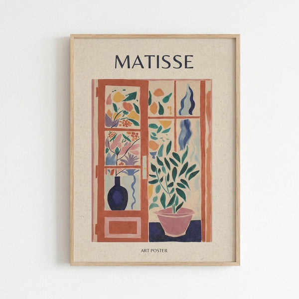 Framed art poster with beige matting featuring a colorful Matisse-style window scene. The artwork shows an orange window frame with multiple panes displaying botanical elements - green leaves, flowers, and a blue vase in various sections. A pink planter with green foliage sits at the bottom right. The composition uses soft pastels and bold shapes in Matisse's characteristic cut-out style. Light wood frame mounted on white wall.