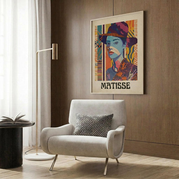 May include: Colorful Matisse-inspired art print of woman in decorative hat displayed in modern living room with beige armchair, geometric pillow, brass floor lamp, and dark wood paneled wall. Poster shows vibrant blues, purples, oranges in artistic portrait style with ornate patterned background elements.