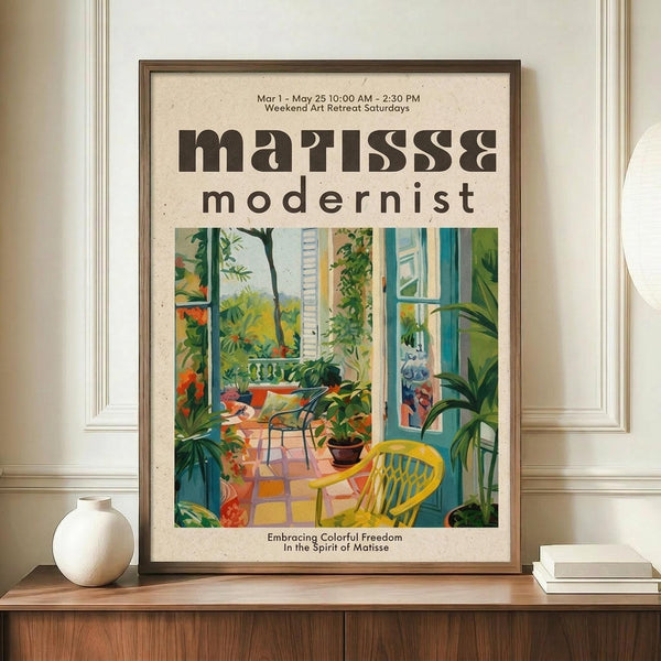 May include: Framed vintage-style art poster featuring colorful interior scene with plants, yellow chair, and windows, displayed on wooden console with white ceramic vase and books against cream paneled wall