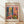 May include: Framed vintage-style poster featuring Henri Matisse's colorful interior scene with tropical plants, open blue shutters, and vibrant artwork on walls in pink, yellow, orange and green tones. Text reads "MATISSE" and "06200 NICE, FRANCE" on cream background. Natural wood frame sits on light wooden floor against white wall with soft shadows.