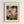 May include: Framed art print hanging on white wall featuring Paul Klee's abstract watercolor artwork with vibrant geometric shapes in blues, reds, yellows, and earth tones. The composition shows overlapping translucent forms and delicate line work characteristic of Klee's style. Text reads "PAUL KLEE" at top and "KUNSTMUSEUM BASEL MUSEUM - 1914" at bottom on cream-colored paper with natural wood frame.