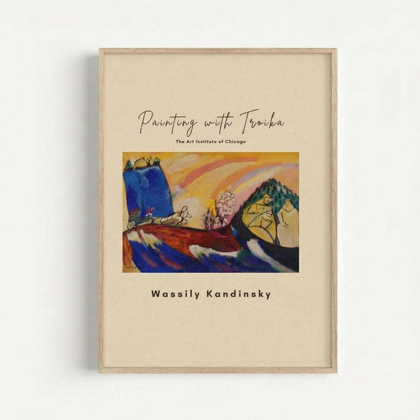 May include: Framed museum poster print mounted on white wall, featuring Wassily Kandinsky's colorful abstract painting with bold blue, yellow, red and green brushstrokes. Cream-colored background with elegant script title "Painting with Troika" and "The Art Institute of Chicago" text. Light wood frame with clean minimal styling against neutral backdrop.