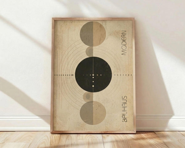 May include: Framed abstract geometric poster with vertical arrangement of circles in olive green, tan, and dark forest green on aged beige background. Features concentric curved lines, dotted elements, and "MODERN" and "BAUHAUS" text along right edge. Natural wood frame leaning against white wall on light wooden floor with soft window lighting.