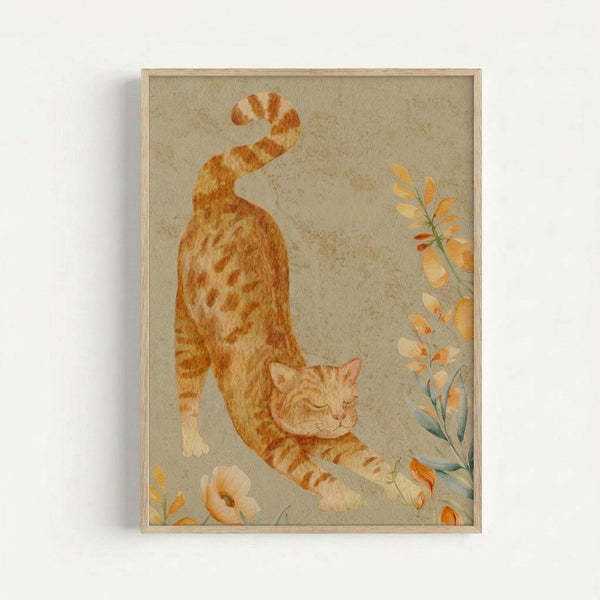 Watercolor illustration of an orange tabby cat in a stretching pose with curved back and raised tail, surrounded by delicate botanical elements including orange and yellow flowers on stems. The artwork has soft, muted tones on a beige textured background and is displayed in a thin wooden frame against a white wall.