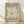 May include: Framed art print with sage green background featuring cream-colored abstract flower or leaf cutout design in Matisse's paper cutout style. Text reads "MATISSE" at top and "PAPIERS DÉCOUPÉS" at bottom. Natural wood frame sits on light wooden floor against white wall with soft window light creating shadows across the scene.