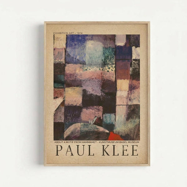 Framed exhibition poster featuring Paul Klee's abstract artwork "About a Motif from Hammamet" from 1914. The composition shows geometric blocks in muted colors including purple, pink, brown, yellow, and teal arranged in a mosaic-like pattern. Text at top reads "EXHIBITION ART - 1914" and bottom shows museum attribution and artist name in large letters. The poster has a cream background and is displayed in a light wood frame against a white wall.