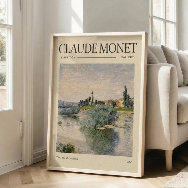 May include: Framed Claude Monet exhibition poster leaning against beige armchair in bright living room. Poster features impressionist river landscape painting with green foliage, water reflections, and soft cloudy sky in muted blues and greens. Cream-colored matting with gallery-style text layout. Natural sunlight streams through tall windows onto light wooden floors.