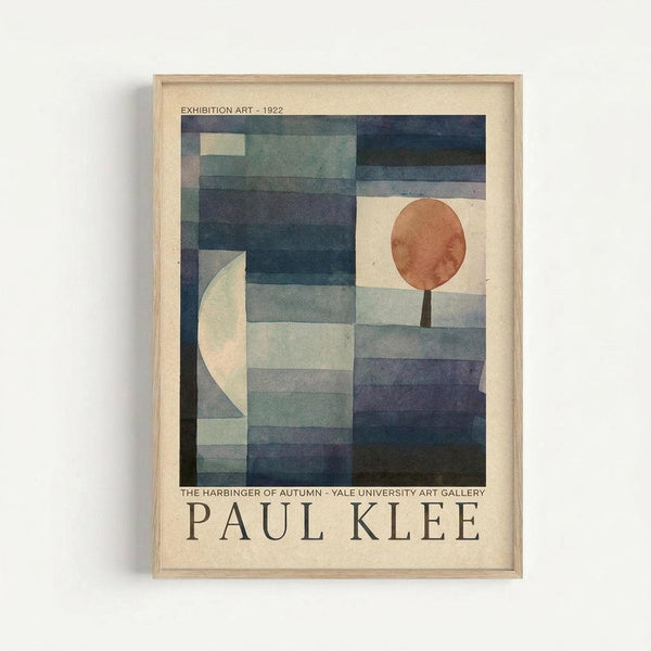 Framed abstract geometric artwork with horizontal bands in blue, teal, and gray tones. Features a cream-colored crescent shape on the left side and an orange-brown circle in the upper right, resembling a stylized tree or lollipop form. Exhibition poster format with text at top and bottom on cream background. Light wood frame against white wall.