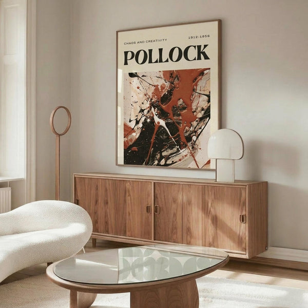 May include: Jackson Pollock abstract art poster with red, black and white paint splatters hanging above a wooden sideboard in a modern living room. White curved chair and glass coffee table visible in foreground. Poster shows chaotic drip painting style with dynamic brushstrokes and paint drips against cream background.