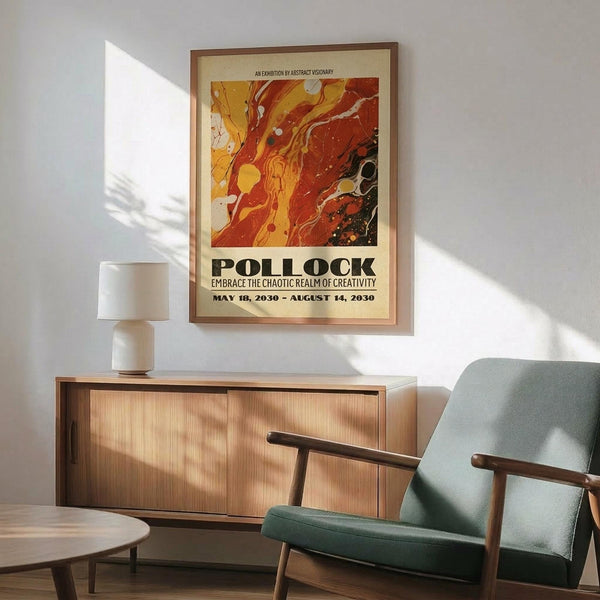 May include: Framed abstract art poster with swirling orange, red, and yellow paint splatters hanging above a wooden sideboard in modern living room. Mid-century green upholstered chair with wooden arms sits beside round coffee table. White ceramic lamp on credenza. Warm natural sunlight creates shadows on white wall.