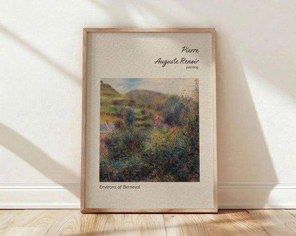 May include: Framed art print of an Impressionist landscape painting showing rolling hills, lush vegetation, and mountains in soft greens, blues, and earth tones. The wooden frame sits against a white wall on light wood flooring with natural sunlight casting diagonal shadows across the scene.