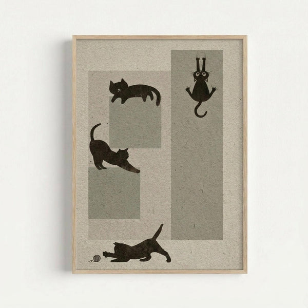 Framed artwork showing four black cat silhouettes in different playful poses against geometric gray and beige rectangular backgrounds. One cat sleeps curled up, another stretches in a downward pose, one hangs upside down with paws up, and one plays with a small ball of yarn. The print has a textured, handmade paper appearance in neutral tones with a light wooden frame, displayed against a white wall.