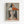 Framed art print featuring a cubist-style portrait of a woman with geometric angular features. She wears a triangular hat in orange, black, white and gray segments, with long dark hair framing her stylized face. Her orange top contrasts against the muted gray background. The piece shows fragmented planes and asymmetrical composition typical of modernist portraiture. Text at bottom reads "PICASSO" and "Interprétation artistique à la manière de Pablo Picasso" in a light wooden frame agains