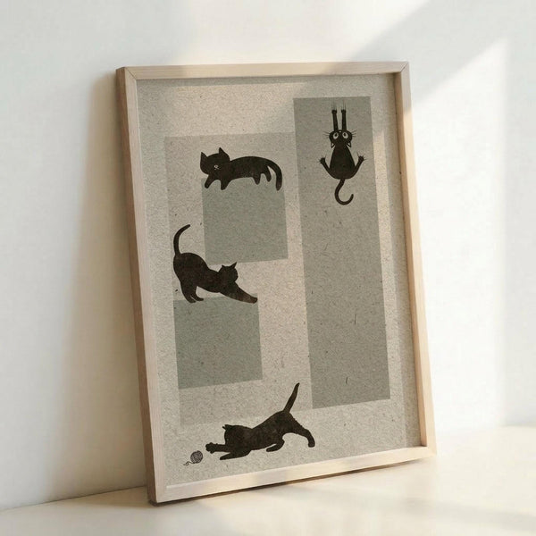 May include: Framed poster print leaning against white wall showing three playful black cat silhouettes on textured cream and gray geometric background. Cats are in different poses - one sleeping, one stretching upward, one playing with a ball. Simple wooden frame, minimalist home decor setting with soft natural lighting.