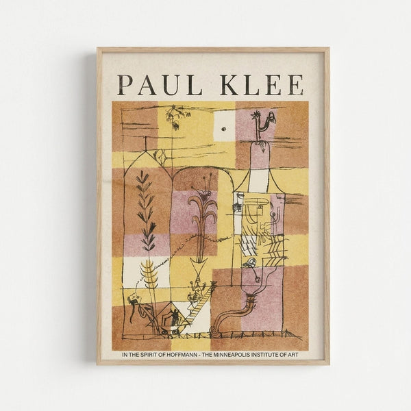 May include: Framed Paul Klee exhibition poster displayed on white wall in light wooden frame. Abstract artwork features warm earth tones of yellow, brown, pink and cream in geometric blocks with botanical and figurative line drawings including plants, human forms, and architectural elements. Museum poster format with artist name at top and exhibition details at bottom.