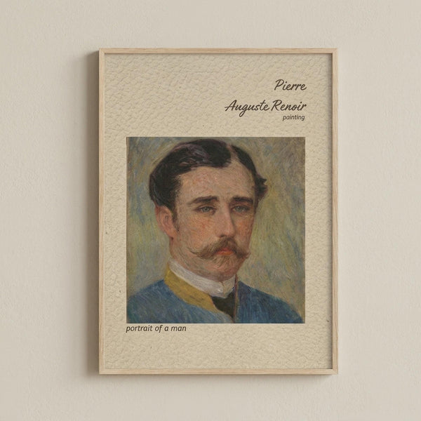 May include: Framed art print hanging on beige wall showing portrait of mustachioed man in blue jacket with yellow collar and white shirt. Cream textured mat displays painting in impressionist style with soft brushstrokes. Text above reads "Pierre Auguste Renoir painting" and below "portrait of a man". Light wood frame surrounds the piece in minimalist room setting.