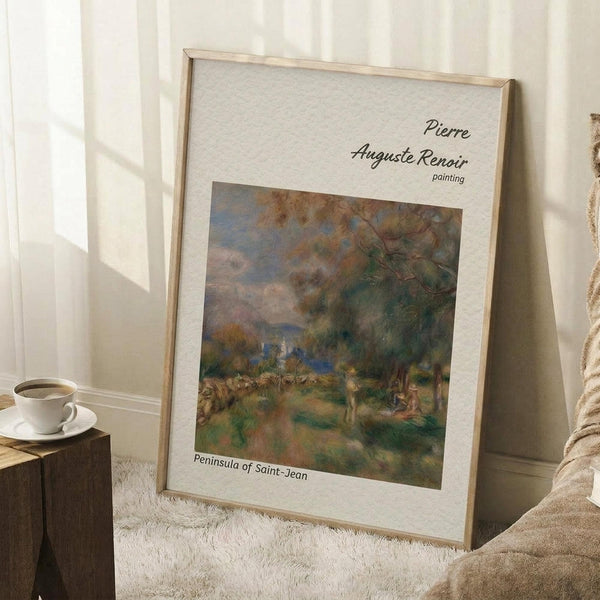 May include: Framed art print leaning against white wall corner on textured cream rug. Light wood frame contains impressionist landscape painting with soft greens, blues, and earth tones showing trees and pastoral scene. White matting displays artist and title text. Coffee cup on wooden block nearby, beige fabric visible at edge.