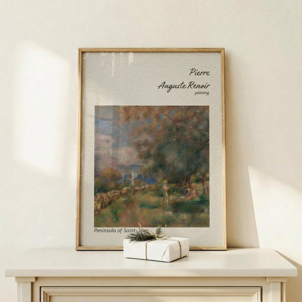 May include: Framed Renoir art print in light wood frame showing impressionist landscape painting with trees, figures, and soft brushstrokes in greens, blues, and earth tones. Print sits on light wood console table against cream wall with small wrapped gift box beside it. Natural lighting creates gentle shadows across the minimal, contemporary room setting.