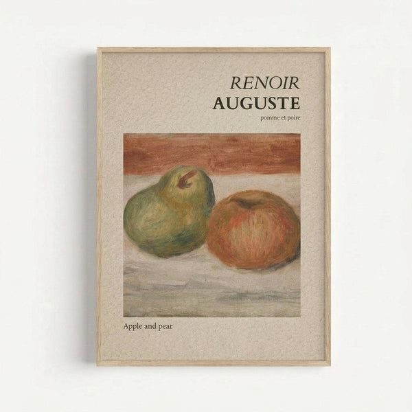 Framed art print featuring Renoir's still life painting of a green pear and red-orange apple on a neutral surface. The artwork is displayed in a light wood frame against a cream textured mat. Text reads "RENOIR AUGUSTE" with "pomme et poire" in French and "Apple and pear" in English below the image. The painting shows soft, impressionistic brushstrokes in muted earth tones.