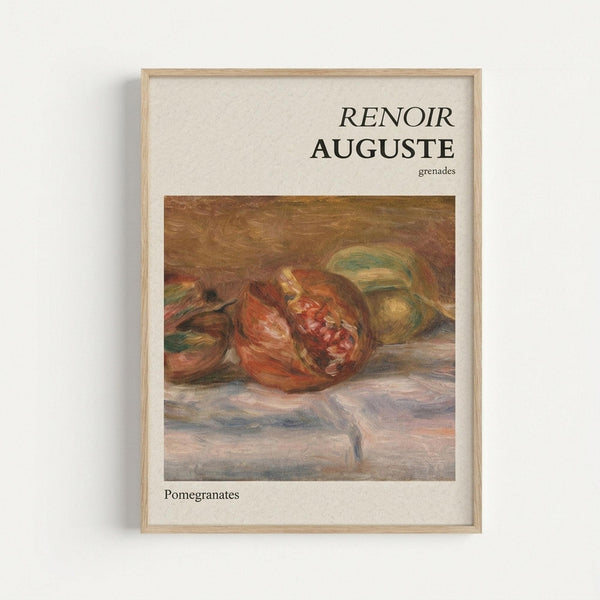 Framed art print showing Renoir's impressionist still life painting of pomegranates in rich reds and oranges with green leaves on a textured surface. The poster has "RENOIR AUGUSTE" and "grenades" text at top, "Pomegranates" at bottom, displayed in natural wood frame against white wall. Warm earth tones and soft brushstrokes characteristic of Renoir's style visible in the fruit arrangement.