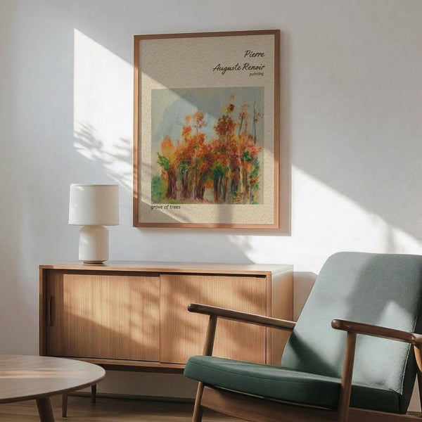 May include: Framed poster of autumn trees with orange and golden foliage in impressionist painting style, displayed above modern wood credenza with white ceramic table lamp. Mid-century sage green armchair with wooden arms positioned nearby in bright, minimalist room with white walls and natural sunlight creating geometric shadows.