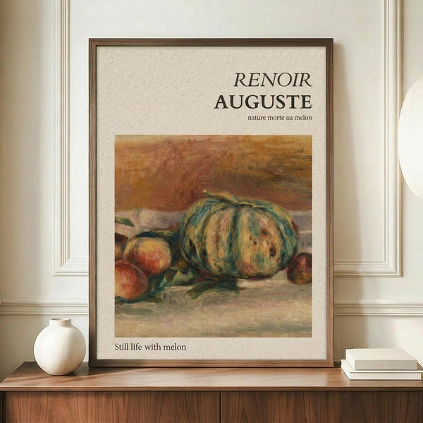 May include: Framed art print featuring Renoir's still life painting of a large striped melon and peaches in warm earth tones, displayed on wooden sideboard next to white ceramic vase and stacked books in elegant room with cream walls and white molding.