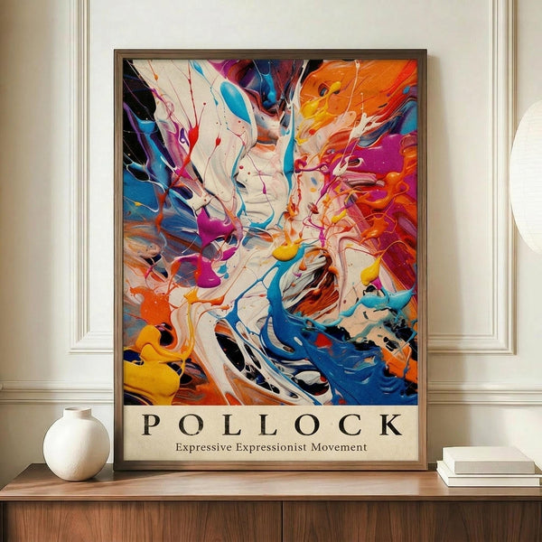 May include: Abstract expressionist poster with dynamic swirling paint splatters in vibrant blues, oranges, reds, and purples against white background, displayed in thin brown frame on wooden sideboard next to white ceramic vase and stacked books in bright room with cream walls and white trim molding.