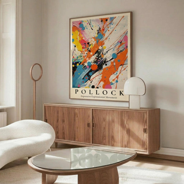 May include: Colorful abstract art poster with vibrant paint splatters in orange, blue, yellow, and pink displayed above a mid-century modern walnut credenza. The framed artwork features dynamic brushstrokes and drips against a cream background. Scene includes a white curved chair, glass oval coffee table, and modern table lamp in a minimalist living room with white walls and natural lighting.