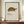 May include: Framed vintage-style botanical print featuring a detailed illustration of a radiated tortoise with intricate golden shell patterns against cream background, displayed on wooden sideboard with small white ceramic vase and stacked books in elegant room with white wainscoting