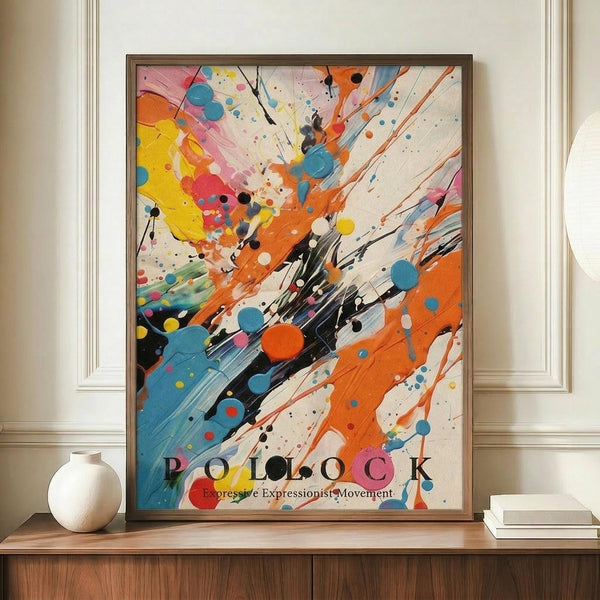 May include: Abstract expressionist poster with dynamic paint splatters and brushstrokes in vibrant orange, blue, yellow, pink, and black on cream background. Text reads "POLLOCK Expressive Expressionist Movement" at bottom. Framed in thin brown frame, displayed on wooden console table next to white ceramic vase and stacked books in elegant room with cream walls and white molding.