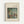 May include: Framed reproduction of Renoir's impressionist painting showing figures by a lake, displayed in a light wood frame with cream matting against a white wall. The artwork features soft brushstrokes in greens, blues, and earth tones depicting people relaxing near water surrounded by lush foliage.