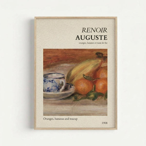 Framed art print featuring a Renoir still life painting with oranges, bananas, and a blue and white porcelain teacup on saucer. The artwork shows warm orange and yellow tones with soft brushstrokes typical of Impressionist style. Text above reads "RENOIR AUGUSTE" with French subtitle, and below states "Oranges, bananas and teacup" with date "1908". The print has a cream-colored mat and light wood frame, photographed against a white wall.