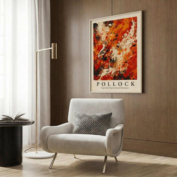 May include: Abstract expressionist poster with vibrant red, orange, and black paint splashes in white frame, displayed above beige upholstered chair with geometric pillow. Modern living room setting features wood paneled wall, brass floor lamp with white shade, and dark round side table with open book.