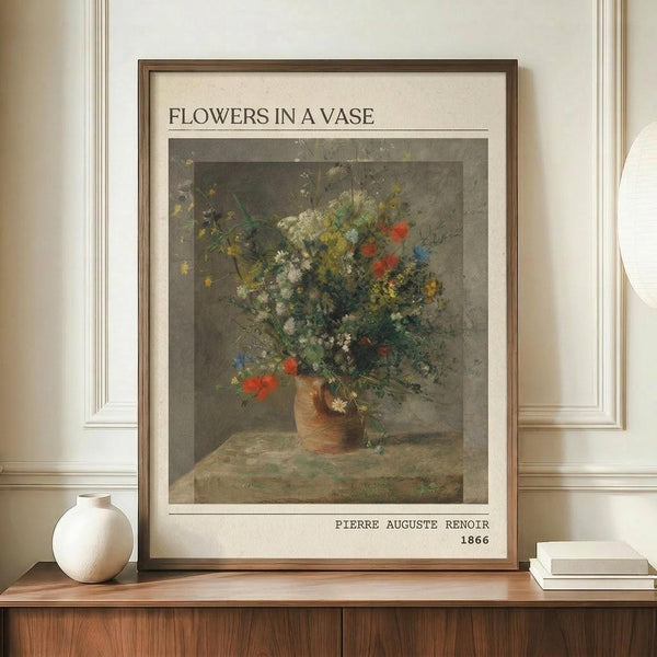 May include: Framed vintage-style poster print featuring Impressionist wildflower bouquet in earthenware vase, displayed on wooden sideboard with white ceramic vase and books in elegant room with cream walls and white molding.