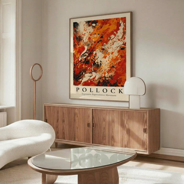 May include: Abstract expressionist art print with vibrant orange, red, and black paint splatters displayed in thin wooden frame above walnut credenza in modern living room. White sculptural chair and glass oval coffee table complete the minimalist scene with natural lighting casting soft shadows on cream walls.