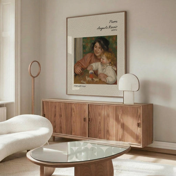May include: Renoir's "Child with Toys" poster displayed in modern living room with warm wood credenza, white sculptural chair, glass oval coffee table, and contemporary white lamp. The vintage art print shows a woman in rust-colored clothing with blonde child playing with toys, framed in thin wood frame against cream textured mat on white wall.
