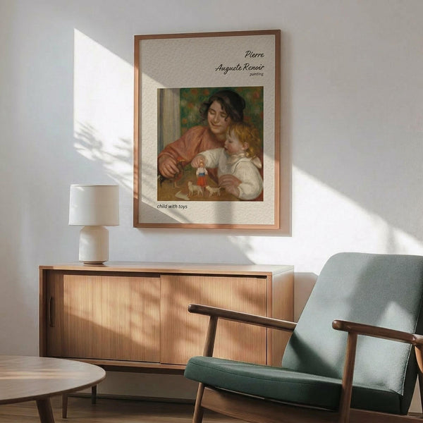 May include: Framed Renoir reproduction poster showing a woman in orange dress with blonde child playing with toys, displayed on white wall above wooden credenza with table lamp, next to mint green mid-century modern armchair with wooden arms in sunlit room with hardwood floors.