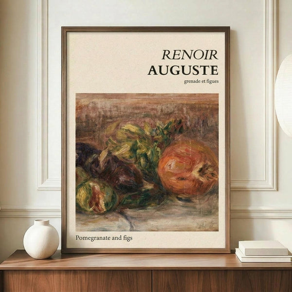 May include: Framed art print displaying Renoir's impressionist still life painting of pomegranates and figs in warm orange, green, and brown tones, positioned on wooden sideboard next to white ceramic vase and stacked books in elegant room with cream walls and white trim molding.