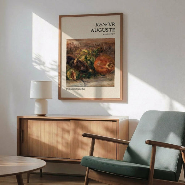 May include: Framed Renoir art print featuring pomegranates and figs in warm orange, green, and brown tones, displayed above a wooden sideboard in a modern living room with mint green armchair, white table lamp, and natural sunlight creating geometric shadows on white walls.