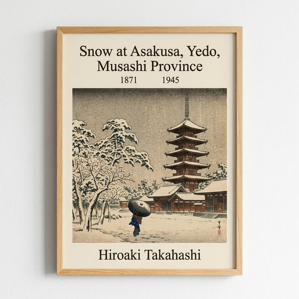 Framed vintage Japanese woodblock print showing a snow-covered temple scene with a five-story pagoda, snow-laden trees, and a figure with an umbrella walking through the snowy grounds. The artwork features muted earth tones and traditional ukiyo-e style, displayed in a light wooden frame against a white wall with text identifying the artwork and artist.