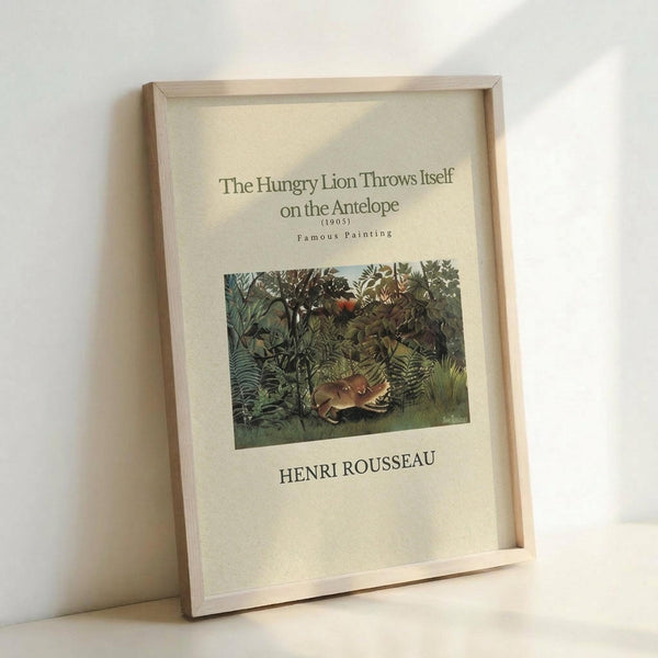 May include: Framed art print featuring Henri Rousseau's jungle painting with a lion attacking an antelope in dense green foliage. The poster has cream background with black text showing the artwork title, date (1905), "Famous Painting" and artist name. Natural wood frame leans against white wall, casting soft shadows.