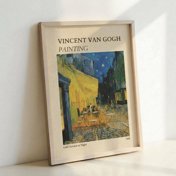 May include: Framed poster print of Van Gogh's Café Terrace at Night painting displayed against white wall. Shows yellow café building with outdoor seating under starry blue night sky, cobblestone street scene. Light wooden frame contains cream-colored mat with artwork title and 1888 date. Print features vibrant yellows, blues, and greens in Van Gogh's distinctive brushstroke style.