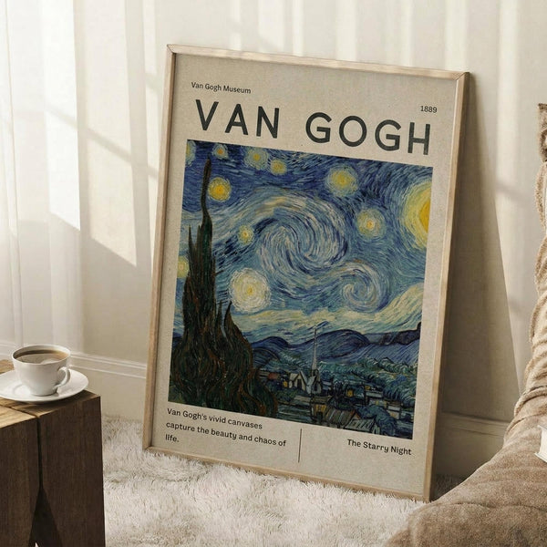 May include: Framed Van Gogh museum poster featuring The Starry Night painting with swirling blue sky, bright yellow stars, dark cypress tree, and village below. Light wood frame leans against white wall corner next to wooden side table with white coffee cup. Beige textured rug and tan blanket visible in cozy room setting.