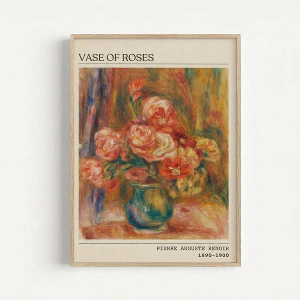 A framed art print featuring Renoir's impressionist painting of pink and coral roses arranged in a blue-green vase. The artwork displays soft, loose brushstrokes with warm tones of orange, yellow, and red in the background. Text above reads "VASE OF ROSES" and below shows "PIERRE AUGUSTE RENOIR 1890-1900". The print has a cream-colored mat and light wooden frame, displayed against a white wall.