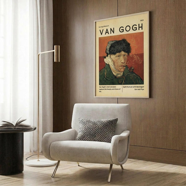 May include: Van Gogh museum poster featuring his 1889 self-portrait with bandaged ear and pipe, displayed on wood-paneled wall above cream upholstered armchair. The vintage-style print shows warm orange background with the artist wearing dark fur hat and green coat. Modern reading nook setting with brass floor lamp, geometric patterned pillow, and open book on dark side table.