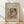 May include: Framed art print leaning against white wall on light wood floor with natural sunlight shadows. Features Pierre-Auguste Renoir's impressionist painting of a woman in white holding a blonde child in orange-red clothing. Warm peachy tones with soft brushstrokes. Text reads "Pierre Auguste Renoir painting" and "washerwoman and child" on beige textured background. Natural wood frame.