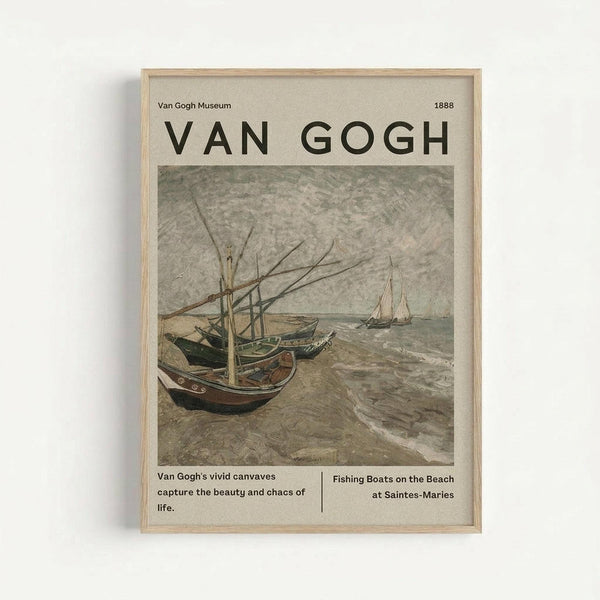 Framed museum-style poster featuring Van Gogh's painting of fishing boats pulled up on a beach. The artwork shows weathered boats with masts in muted earth tones against a gray sky, with another sailboat visible in the distance. The poster has cream-colored background with "VAN GOGH" in large black letters at top, museum attribution, and descriptive text below the image. Light wooden frame against white wall.